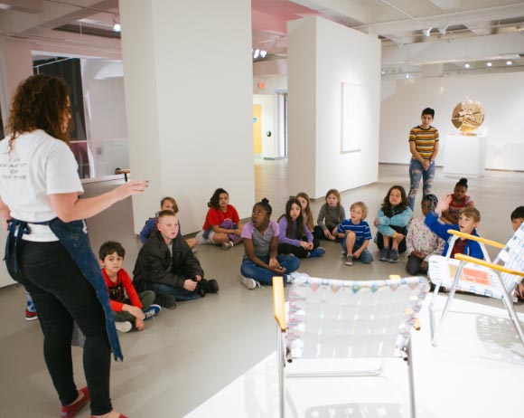 instructor talking with kids during Summer Camp at MOCA