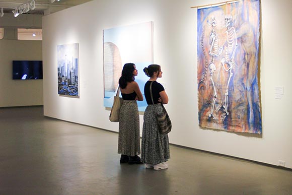 two teens looking at artwork