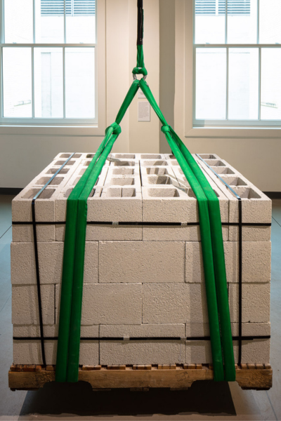 artwork by Brennan Wojtyla featuring hanging cinder blocks on a pallet