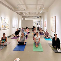 people in a gallery doing yoga