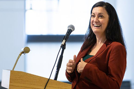 Caitlín Doherty at a podium