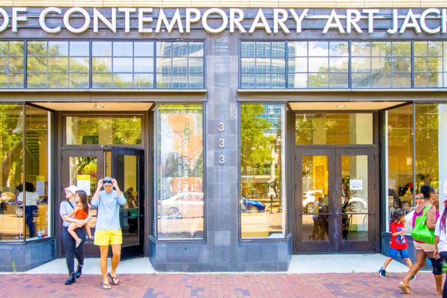 the exterior of the MOCA Jacksonville building with people entering and exiting the front doors