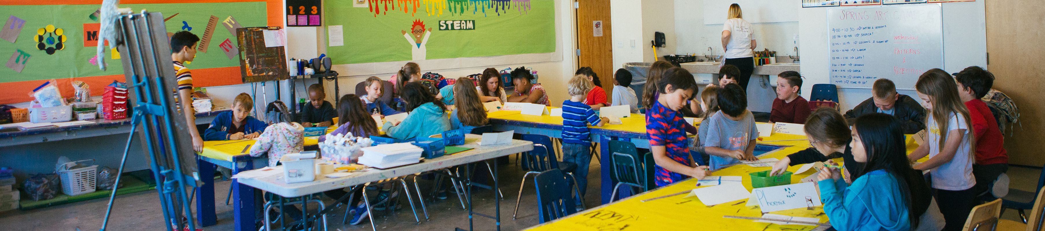 MOCA studio classroom filled with children working on art projects