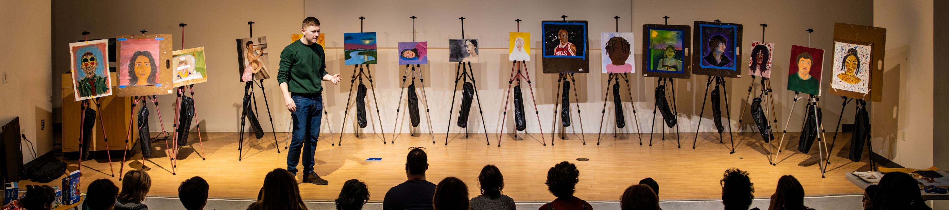 a collection of student artwork displayed on a stage