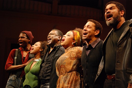 actors standing in line singing