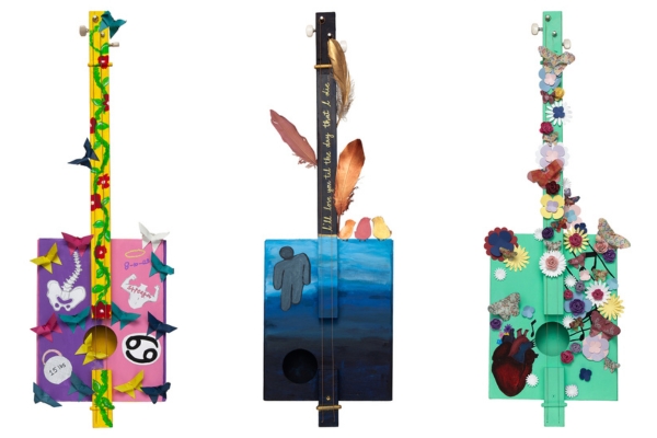 three guitars painted by pediatric patients 