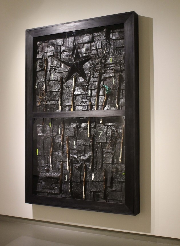 artwork by Radcliffe Bailey featuring a large shadow box filled with dark objects and a star