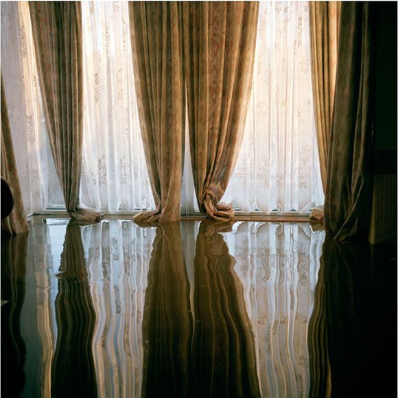 a room with curtains and water filling the floor