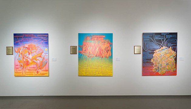 three pieces of artwork hanging on a gallery wall
