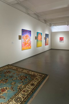 rug and four art pieces on the wall