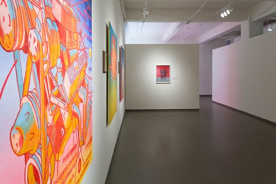 view along the gallery with three pieces of artwork