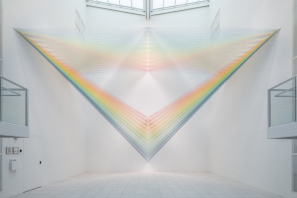 artwork by Gabriel Dawe that features colored strings hung across the Atrium Gallery mimicking a light prism