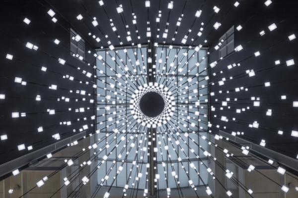 artwork by Kedgar Volta featuring small lights on a black circular structure 