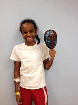 teenager holding his mask