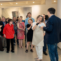 People gathered in a gallery during artist-led exhibition tour
