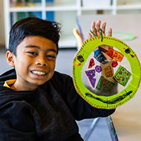 boy holding a piece of art