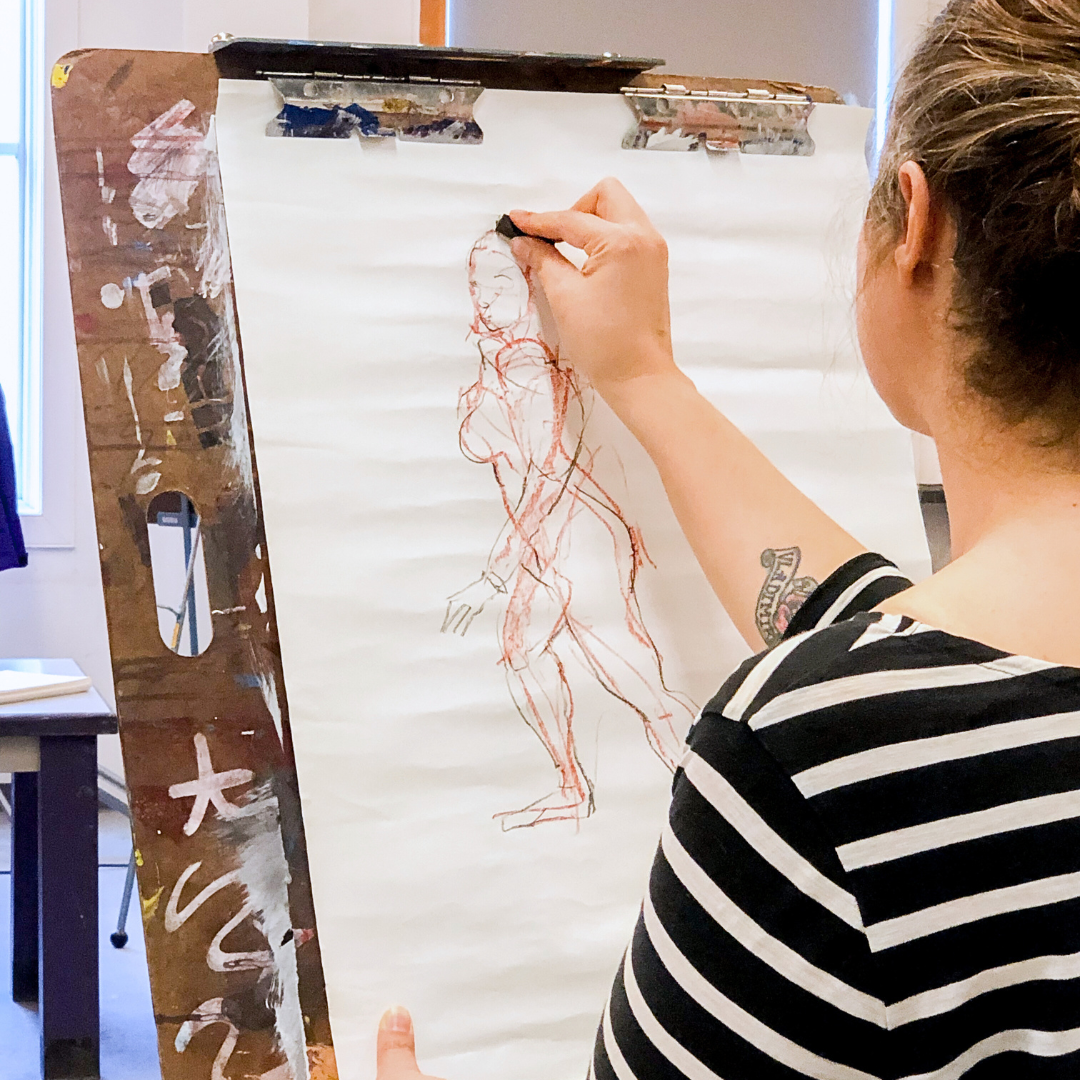 a participant at MOCA's Art of the Figure Workshop working on a drawing
