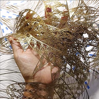 gold papercut ribbons in a hand