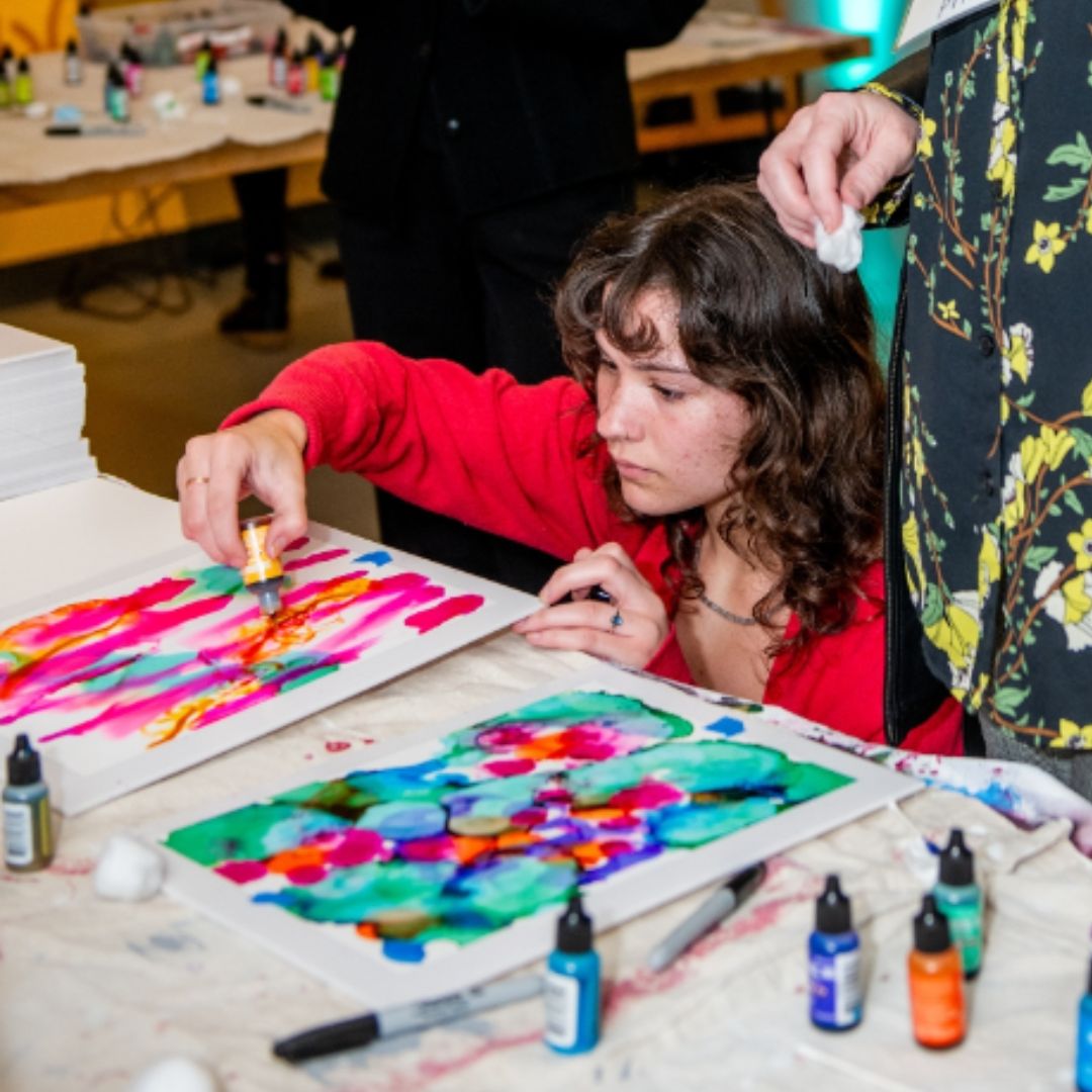 someone making art with alcohol ink during an event at MOCA