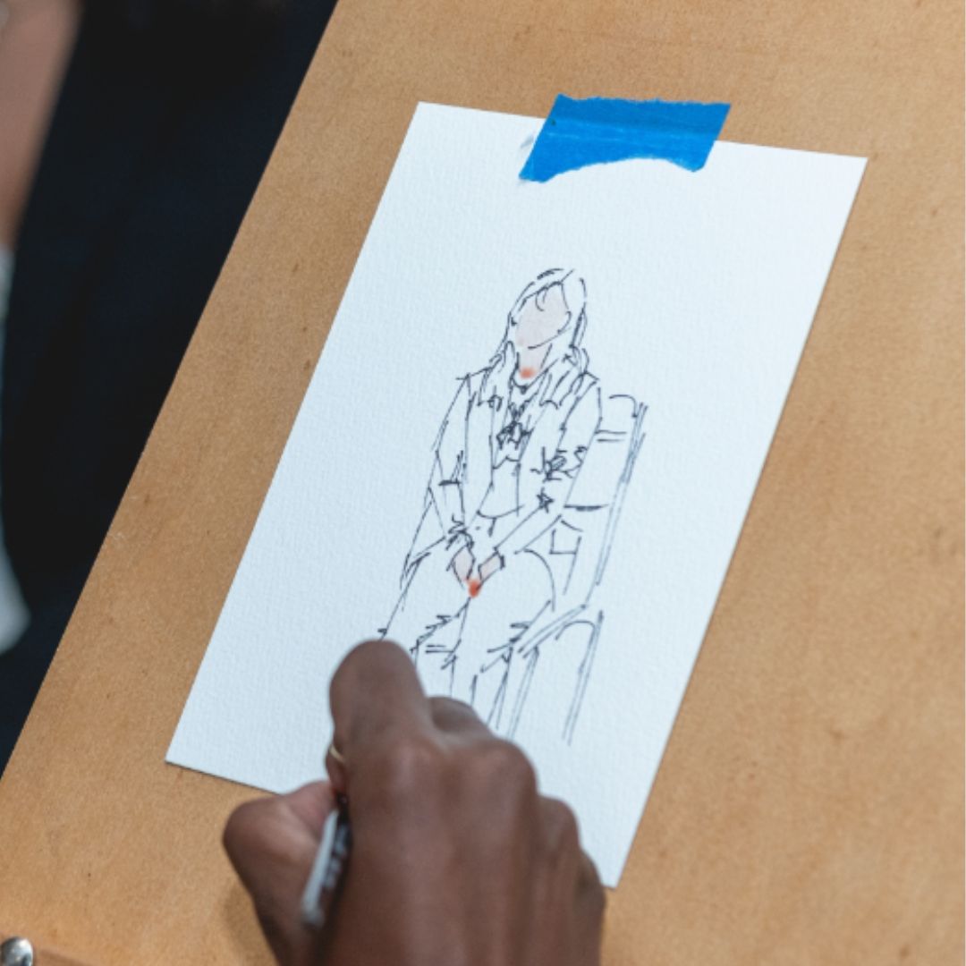 close up of artist Teresa Cook's hand as she draws a portrait