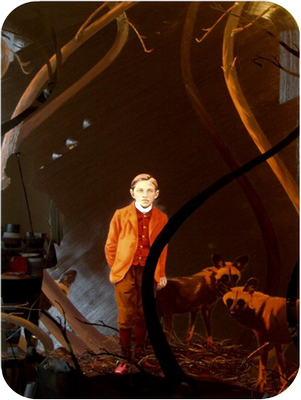 Oil painting on black plexiglass of boy and wild dogs