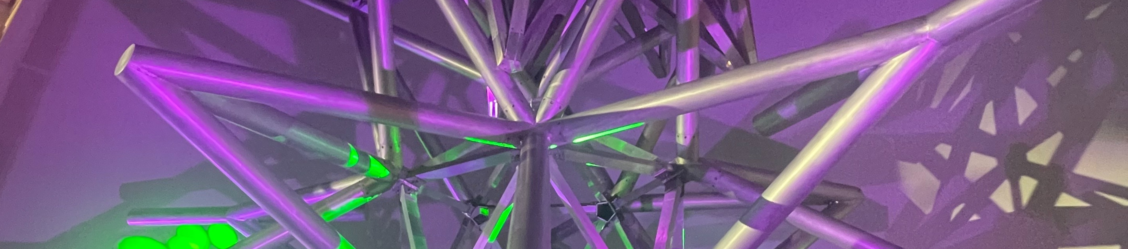 Project Atrium: Frank Stella Jacksonville Stacked Stars lit up with purple and green lights during MOCA's Centennial Gala