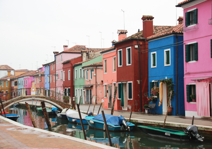 Brightly colored homes along canal in Burano Italy  