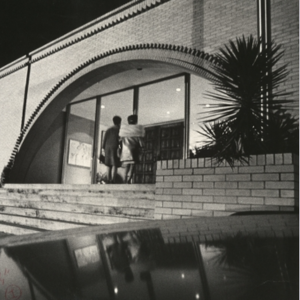 Black and white image of two guests entering  the previous MOCA building